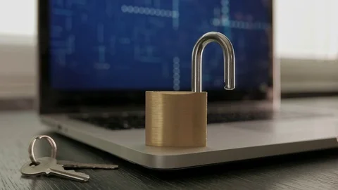 Unlocked Padlock on top of computer laptop. With Keys. Stock-Footage 75693528