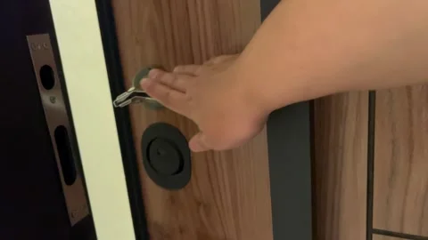 Unlocking and Opening a Wooden Front Door to Enter a Home Video stock 345741035