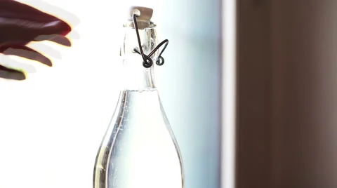 Unlocking a bottle of sparkling water Stock-Footage 56375534