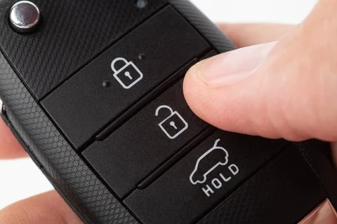 Unlocking a car with button on the keychain. Stock Photos