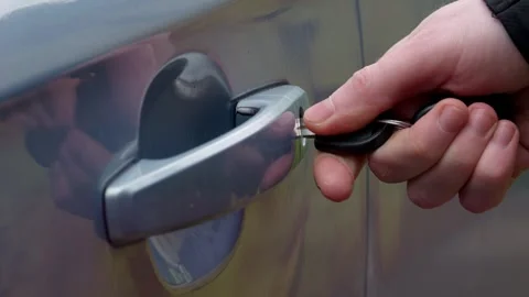 Unlocking a Car Door with a Key Engaging Action Sequence in Real Life Situations Stock Footage 309334460