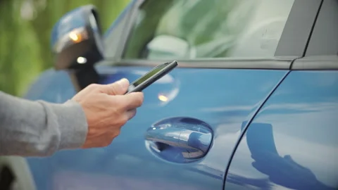Unlocking car door with smart phone keyless system Stock Footage 311935517