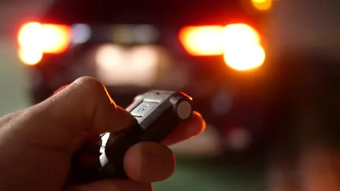 Unlocking a Car at Night Using the Key Fob Button Video stock 140471998