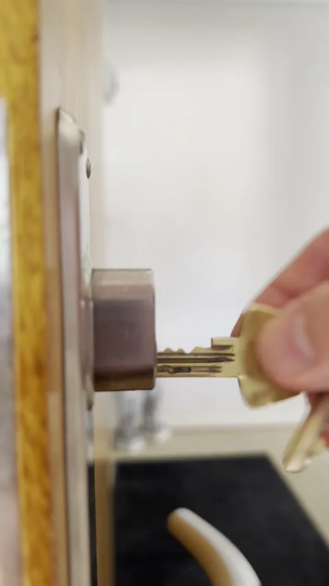 Unlocking a door with a key Stock Footage 339679730