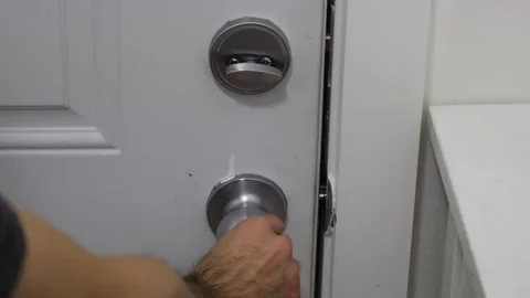 Unlocking door opening deadbolt and door handle from inside home access concept Stock Footage 331769600