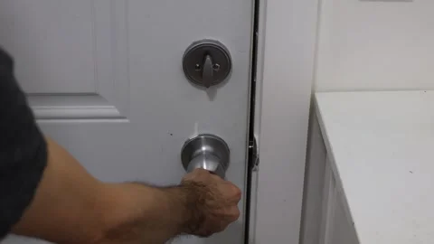Unlocking door opening deadbolt and door handle from inside home access concept Stock Footage 331769601