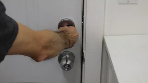 Unlocking door turning deadbolt from inside home security access concept Stock Footage 331769591