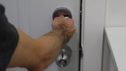Unlocking door turning deadbolt from inside home security access concept Stock Footage 331769593