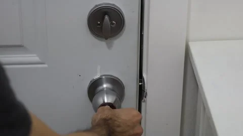 Unlocking door turning deadbolt from inside home security access concept Stock Footage 331769599