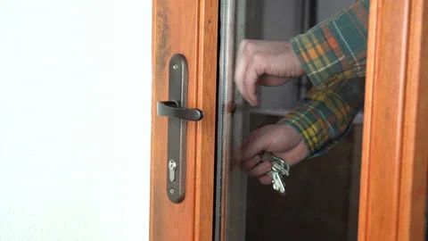 Unlocking the doors with bunch of keys from inside Stock Footage 160735610