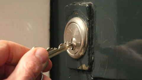 Unlocking the front door. Close up of lock, key and hand. Video stock 176507767