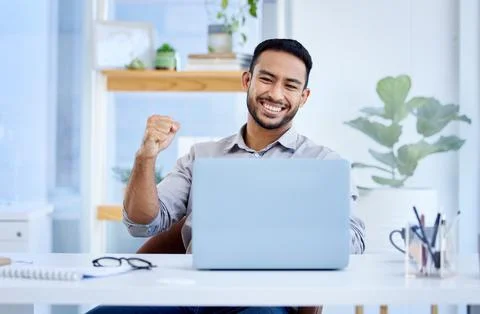 Unlocking his potential with another win. a young businessman cheering while Stock Photos