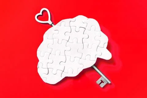 Unlocking Intelligence: Brain Puzzle with Key on Red Foto stock