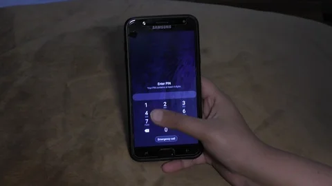 Unlocking mobile phone with code and entering slowly. Stock Footage 127016460