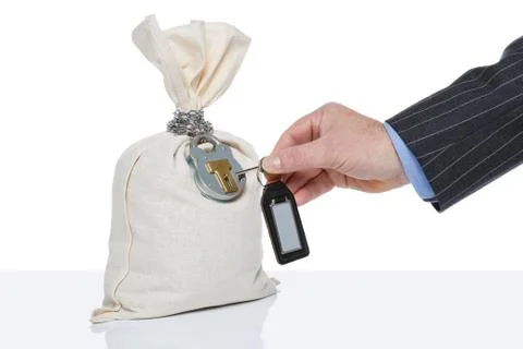 Unlocking a money sack Stock Photos