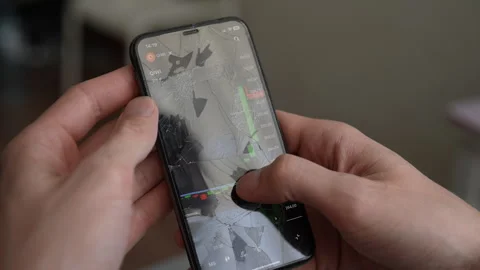 Unlucky trader using smartphone with a broken screen to check stock market data Stock Footage 297629488
