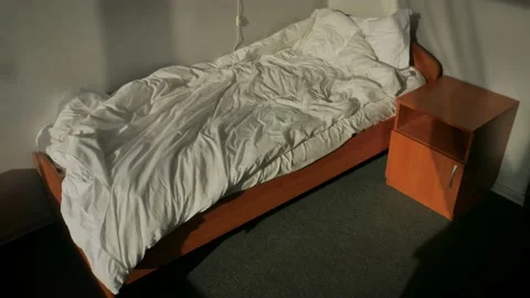 Unmade Bed in bright sunlight. Shadow of a curtain of the window. Time lapse Stock-Footage 166505078