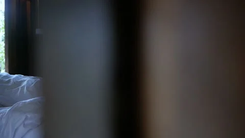 An unmade bed with crumpled bed sheet after waking up in the morning at homestay Stock Footage 135577774
