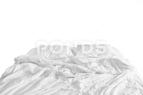 Unmade bed with crumpled bed sheet, a blanket and pillows after comfort duvet Stock Photos