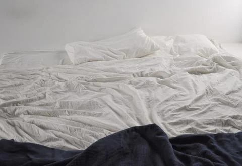 Unmade bed sheets Stock Photos