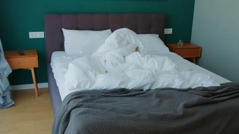 Unmade bed with white sheets. white sheets on the bed. Stock Footage 262900744