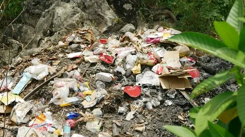 Unmanaged waste dumping of garbage in wrong area digging buried composting Stock Photos