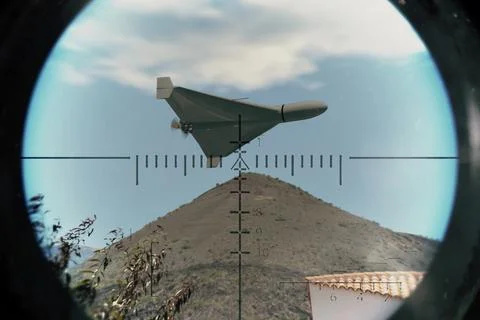 Unmanned drone performs combat mission in mountain area with precise targetin Stock Photos