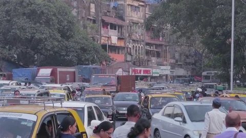 Unorganized slow moving traffic while walking on the road in a downtown Stock Footage 72040430