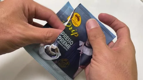 Unpack drip coffee package espresso supreme point of view shot with white table Stock Footage 248117177