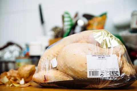 Unpacked from its plastic packaging fresh Capon Chapon cockerel meat on kitchen Stock Photos
