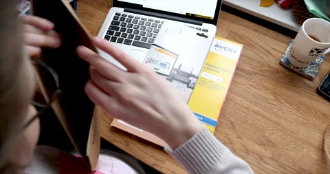 Unpacking Amazon Delivery envelope prime parcel with Avery blank printed labels Stock Footage 153270053