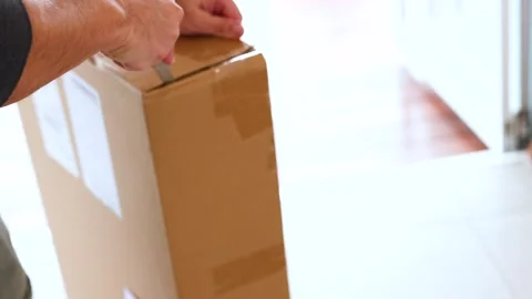 Unpacking a Box in a Bright Room Stock Footage 307163985