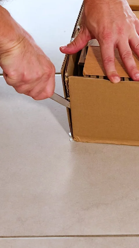 Unpacking a Box with Careful Precision Stock Footage 307291751