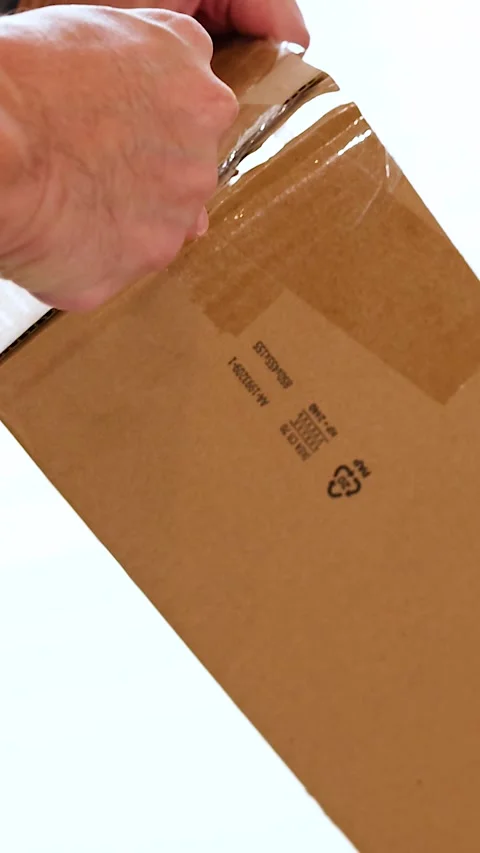 Unpacking a Box with a Cutting Knife Stock Footage 307290917