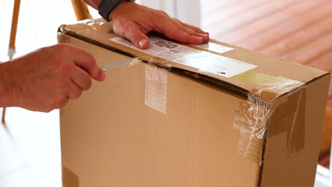 Unpacking a Box with a Knife in Australia Stock Footage 307163703