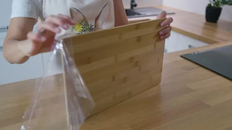 Unpacking the chopping board. New kitchen utensils. Stock Footage 276295291