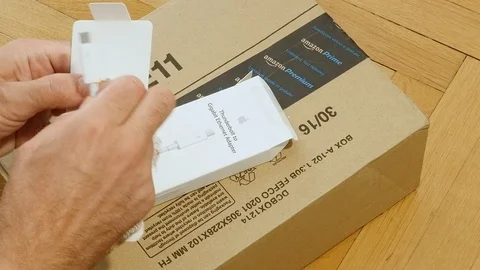 Unpacking new Apple Computer Thunderbolt to Ethernet adapter Stock Footage 114186784