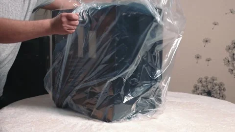 Unpacking new computer case by removing plastic protective wrapping Stock Footage 324591797