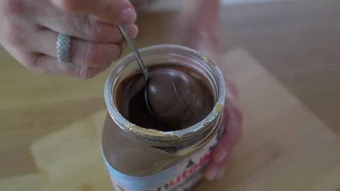 Unpacking the nut paste. Spoon in a jar of nut paste. Stock Footage 276294177