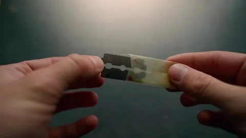 Unpacking an old razor blade from an envelope close-up. Safety razor blade Stock Footage 199272104