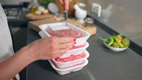 Unpacking of white plastic containers with beef mince bought in butcher's shop Stock Footage 219544841