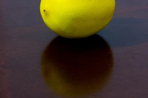 Unpeeled  lemon on the kitchen table Stock Photos
