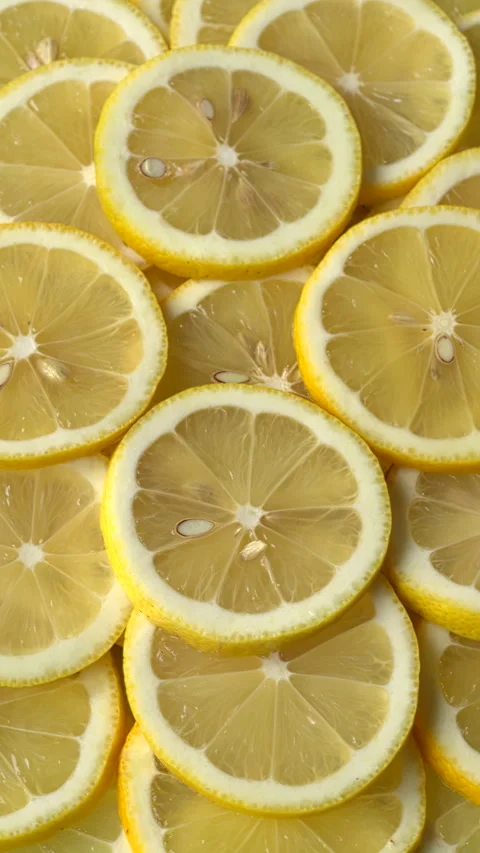 Unpeeled, sliced lemons background.  Vertical video. Video stock 301646083