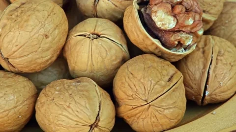 Unpeeled walnuts rotation. Walnut nut with shell. Stock Footage 304599864