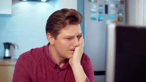 Unpleasantly surprised man at the computer Stock Footage 145132852