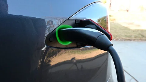 Unplugging a charge cable from an electric car Stock Footage 121001663