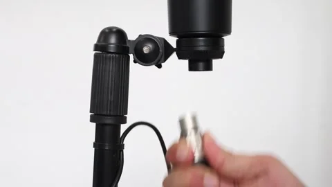 Unplugging a condenser microphone cable, hand removing XLR connector Stock Footage 305780161