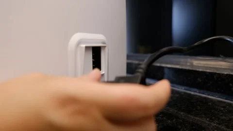 Unplugging a Device from a Kitchen Counter – Appliance Disconnect Stock Footage 302687780