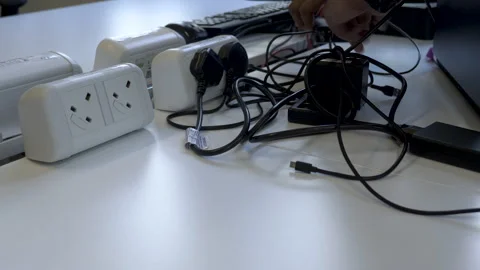 Unplugging Electronic Devices from Electricity Socket, Power Saving Concept Stock Footage 200840721