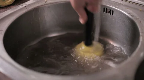 Unplugging a kitchen sink with a small plunger Stock Footage 51840578